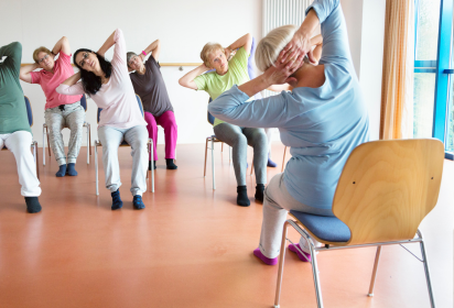 picture of seniors doing chair yoga 
